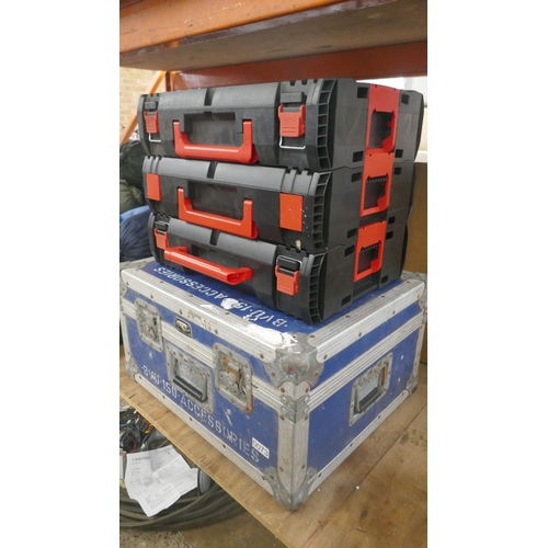 Three Milwaukee stackable tool cases and a metal edged case