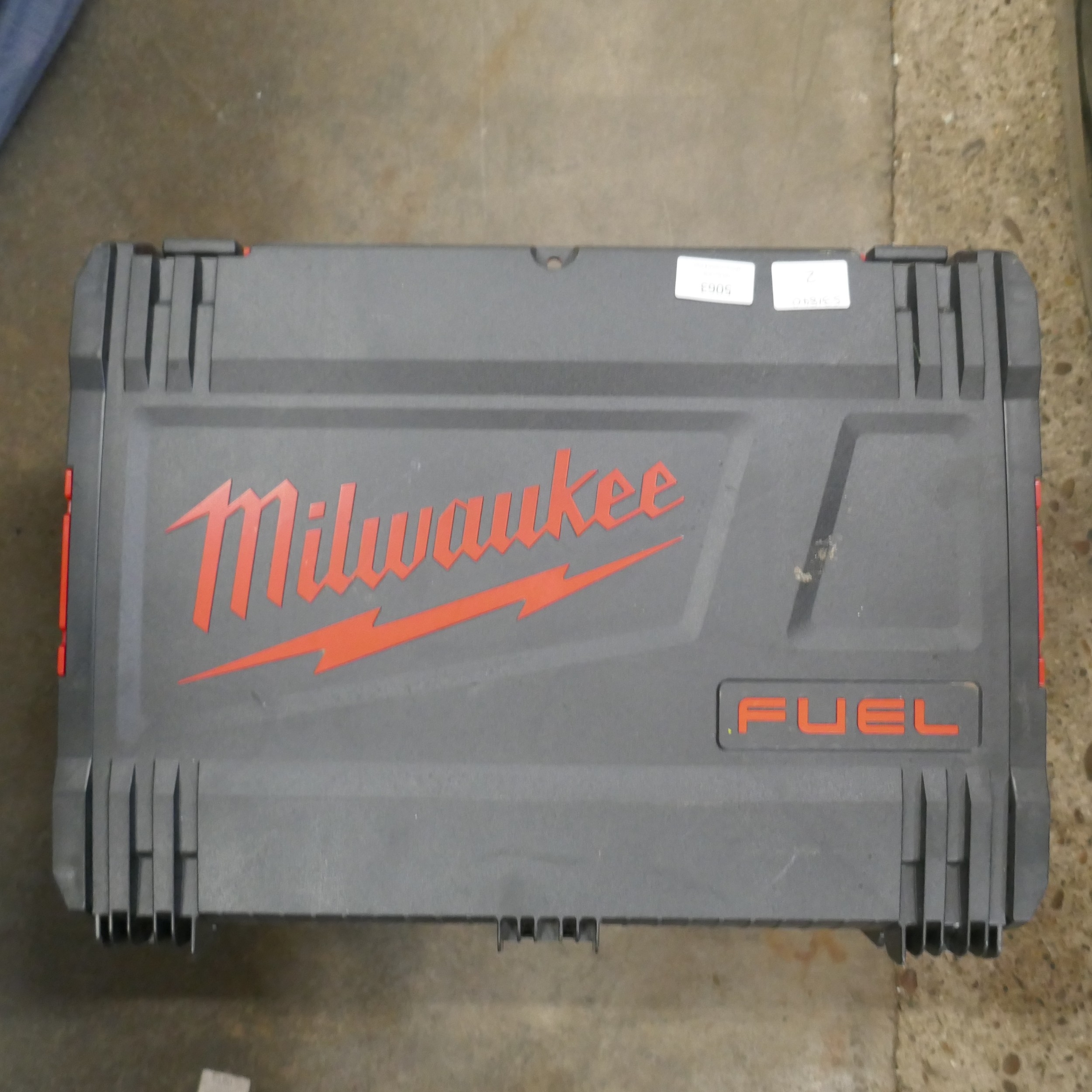 Three Milwaukee stackable tool cases and a metal edged case