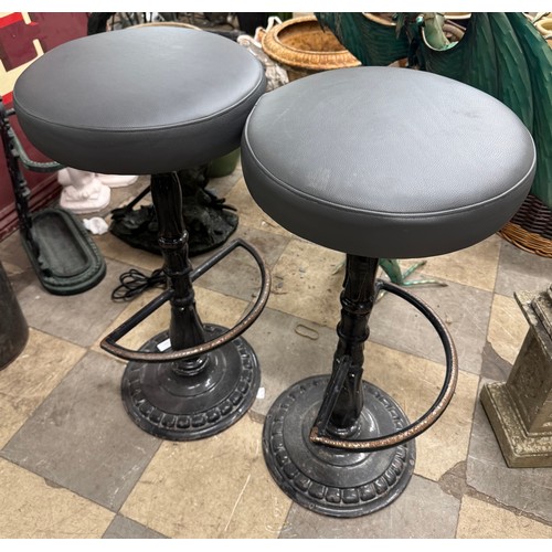 A pair of cast iron bar stools