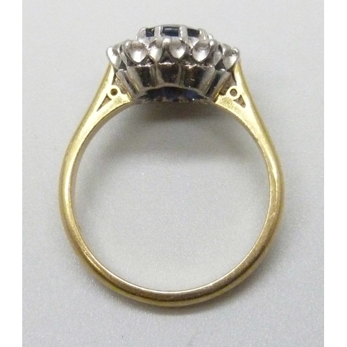 7283 - An 18ct yellow gold sapphire and diamond halo ring, 4.7g, M