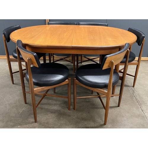 201 - A G-Plan Fresco teak oval extending dining table and a set of six black vinyl chairs