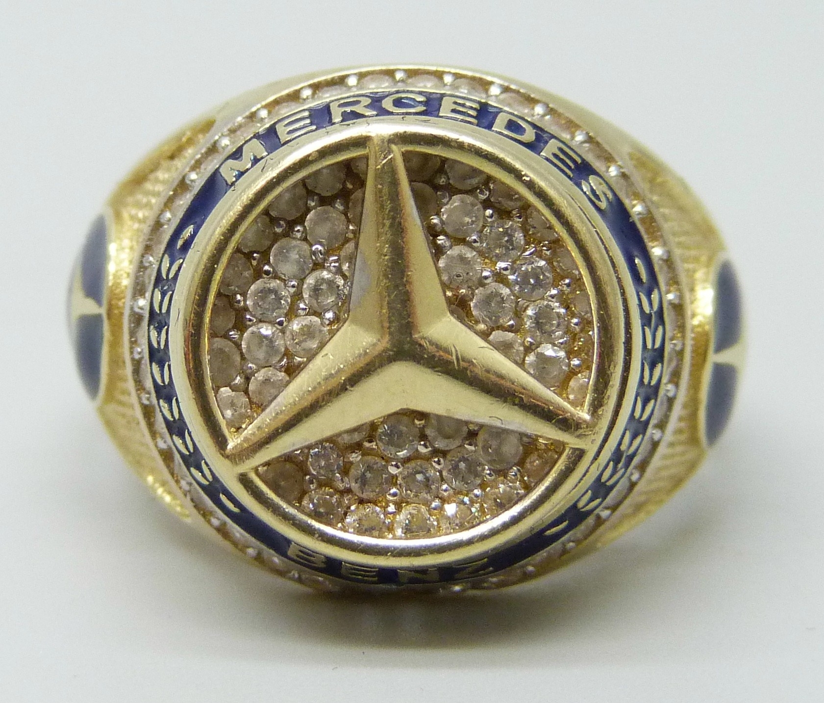 A 14ct gold, enamel and white stone Mercedes Benz design ring, 7.8g, W