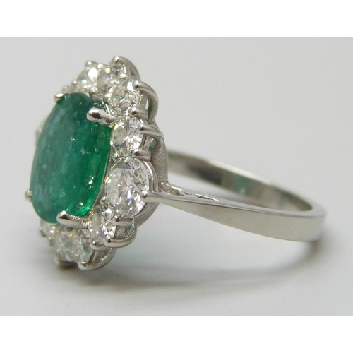 7180 - A platinum set emerald and diamond cluster ring, 6.1g, N/O
