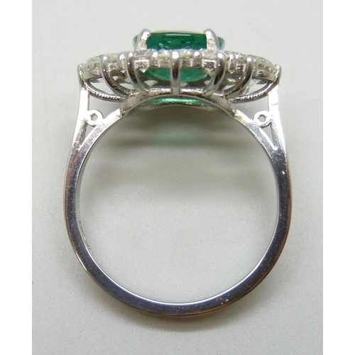 7180 - A platinum set emerald and diamond cluster ring, 6.1g, N/O