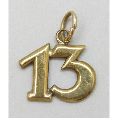 7071 - A yellow metal '13' charm, marked 333, 1.7g, 1.9cm including bail