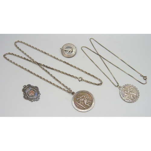 7079 - A collection of silver jewellery - two St Christopher pendants and chains, a silver fob, and a silve... 