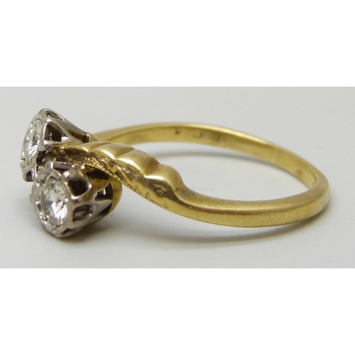 7084 - An 18ct gold and and platinum two stone diamond crossover ring, 4.2g, O
