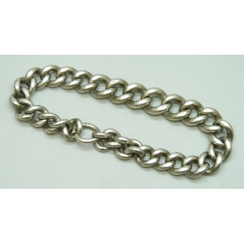 7089 - A chunky silver curb chain bracelet, lacking fastener, 51g