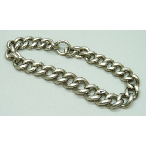 7089 - A chunky silver curb chain bracelet, lacking fastener, 51g
