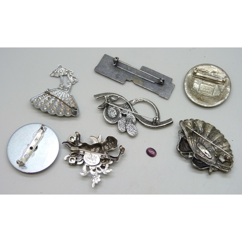 7090 - A collection of brooches including some signed, one cabochon glass stone loose
