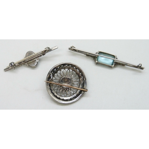 7095 - Three silver brooches, the circular example missing a stone, 2.9cm, stone a/f on blue stone example,... 