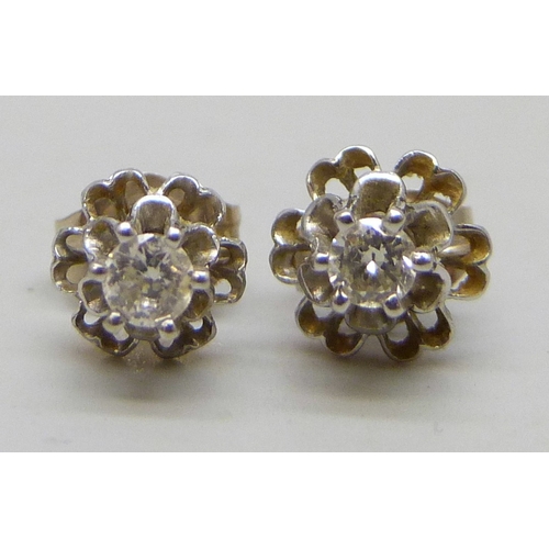 7098 - A pair of white metal set diamond stud earrings, butterflies marked 14k, 0.9g