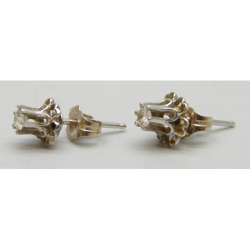 7098 - A pair of white metal set diamond stud earrings, butterflies marked 14k, 0.9g