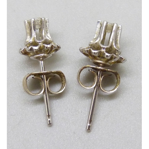 7098 - A pair of white metal set diamond stud earrings, butterflies marked 14k, 0.9g