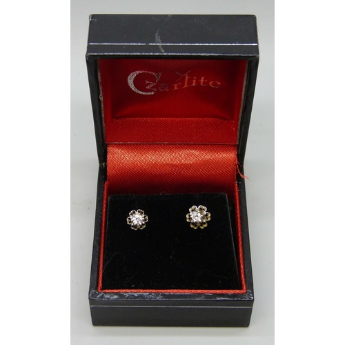 7098 - A pair of white metal set diamond stud earrings, butterflies marked 14k, 0.9g