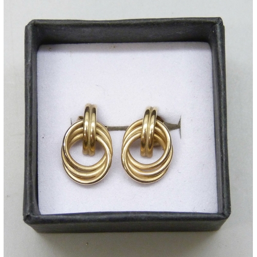 7101 - A pair of yellow metal knot earrings, the butterflies marked, 1.2g, 1.5cm