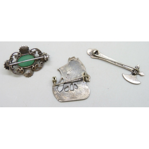 7106 - An Iona Scottish silver ship brooch, an Arts & Crafts silver and chrysoprase brooch, and a silver ax... 