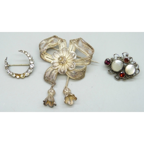 7107 - An Austro-Hungarian white metal pearl and garnet brooch, 2.7cm, a Victorian paste set crescent brooc... 