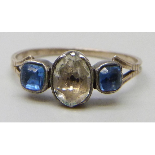7109 - A 19th century yellow and white metal ring, the closed back setting with three paste stones, 1g, K