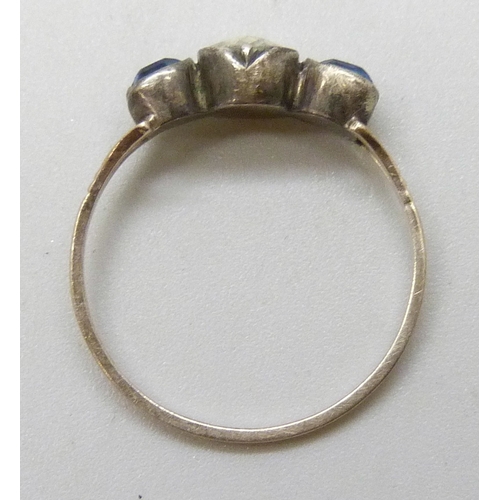 7109 - A 19th century yellow and white metal ring, the closed back setting with three paste stones, 1g, K