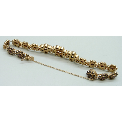 7119 - A Bohemian garnet set gilt metal floral cluster bracelet, 19g, 1.5cm largest cluster