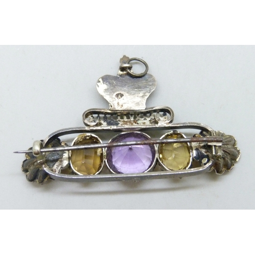 7121 - A large white metal early 20th century brooch set with amethyst and citrine, with crown and shell de... 
