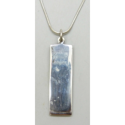 7125 - A silver ingot pendant, 16g, 5cm including bail, on a plated chain