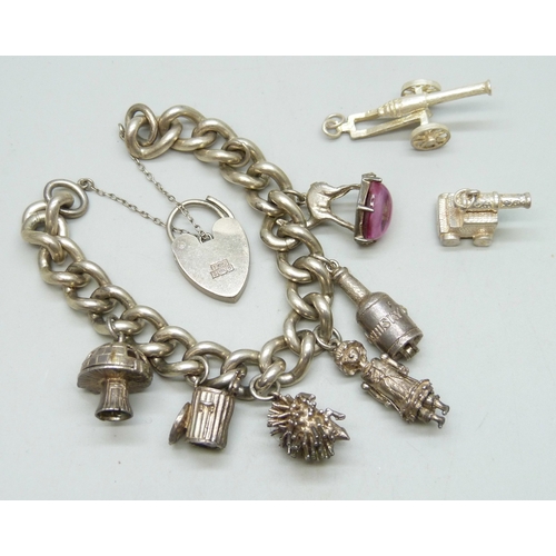 7153 - A silver charm bracelet with a collection of silver and white metal charms including a toadstool and... 