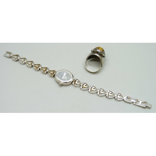 7159 - A white metal ring with control marks to outer shank, Q, and a silver wristwatch, 36g total