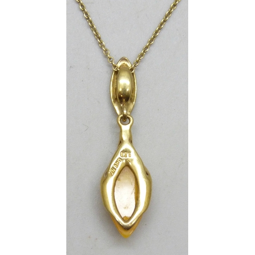 7165 - A silver gilt egg yolk amber pendant, 3.5cm, on a gilt chain, boxed
