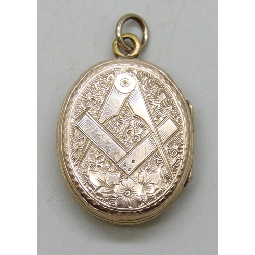 7166 - A yellow metal back and front hand painted enamel locket with Masonic symbol verso, 6.7g, 3cm includ... 