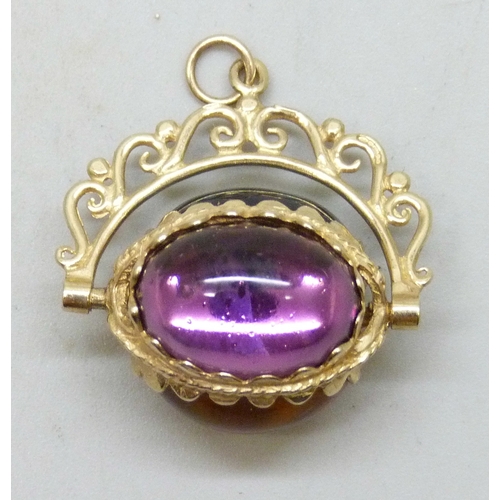 7173 - A 9ct gold swivel fob set with three cabochon glass stones, 6.7g, 2.7cm including bail