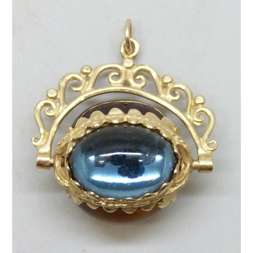 7173 - A 9ct gold swivel fob set with three cabochon glass stones, 6.7g, 2.7cm including bail