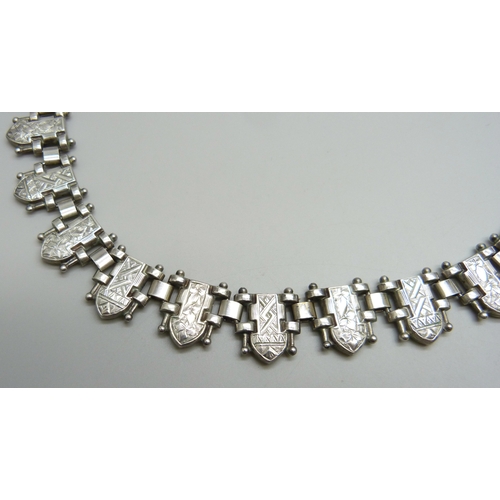 7139 - A white metal Victorian style collar with engraved design, 46g, 45cm