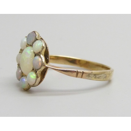 7144 - An early 20th century yellow metal opal cluster ring, some replacement unmatched stones, 1.5g, L