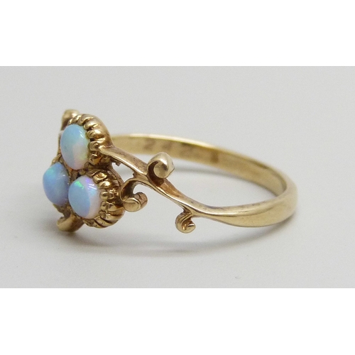 7145 - A 9ct gold and opal three stone ring, 1.8g, M