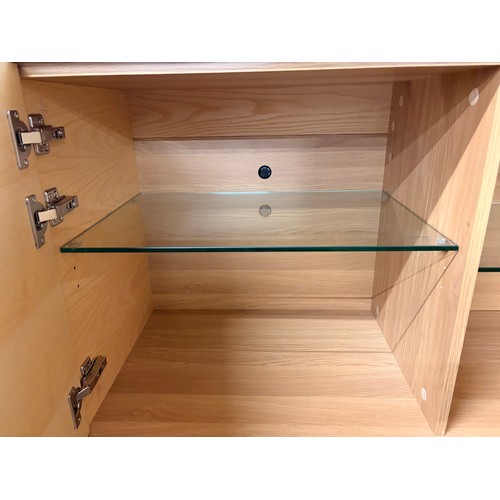 3002 - A Hobang oak 3 door sideboard with glass top