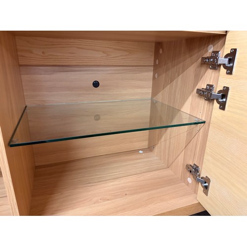 3002 - A Hobang oak 3 door sideboard with glass top