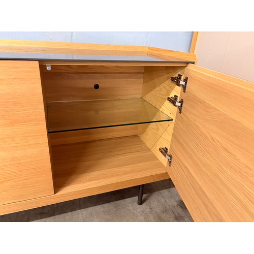 3002 - A Hobang oak 3 door sideboard with glass top