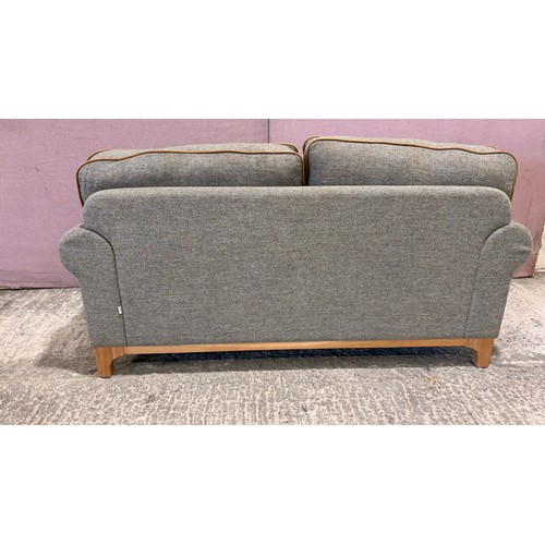 3008 - A Whitwell thistle fabric and tan leather 2 seater sofa (CRES2) (CFD-316-2)