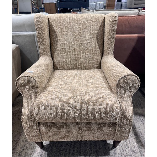 3057 - An Aztec pattern wingback armchair
