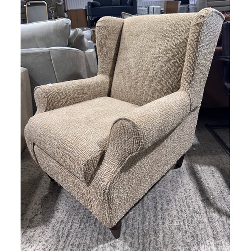 3057 - An Aztec pattern wingback armchair