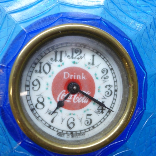 2035 - A blue glass 'Drink Coca Cola' advertising clock, the dial marked made in Germany, 17cm