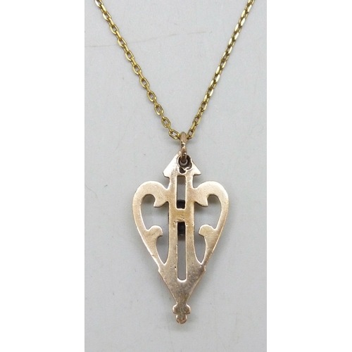 7010 - An Art Nouveau gold plated pendant on a gold plated chain, 3.2cm pendant including bail