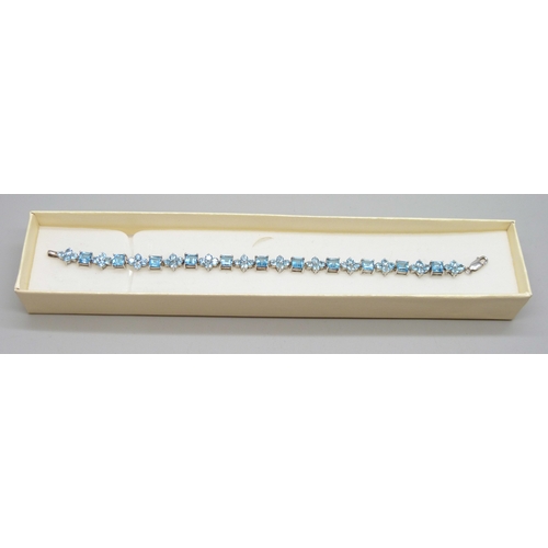 7046 - A silver set blue stone line bracelet, possibly topaz, 12g, 18.5cm