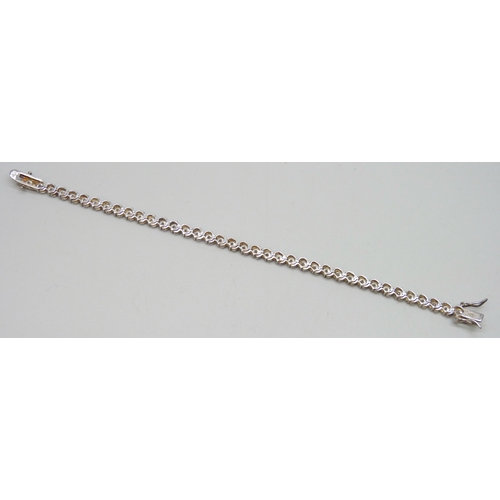 7049 - A silver set cubic zirconia line bracelet, 12g, 18.5cm