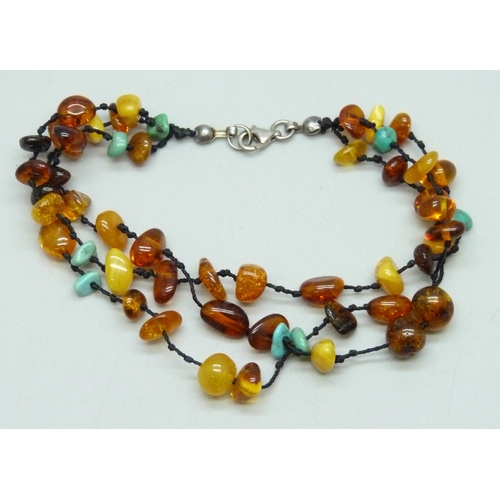 7056 - A gemstone bracelet with a silver clasp including egg yolk amber and turquoise,