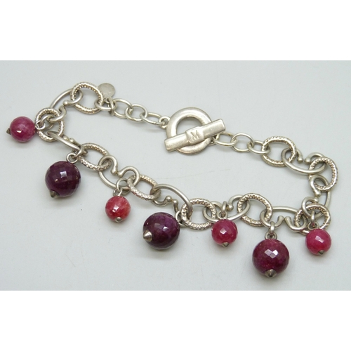 7061 - A silver bracelet set with faceted pink gemstone drops, possibly synthetic spinel, 28g, 22cm
