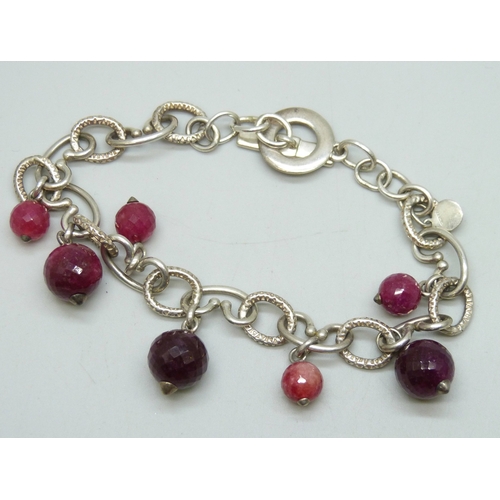7061 - A silver bracelet set with faceted pink gemstone drops, possibly synthetic spinel, 28g, 22cm