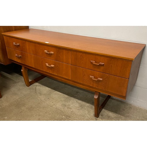 58 - A teak six drawer bowfront sideboard